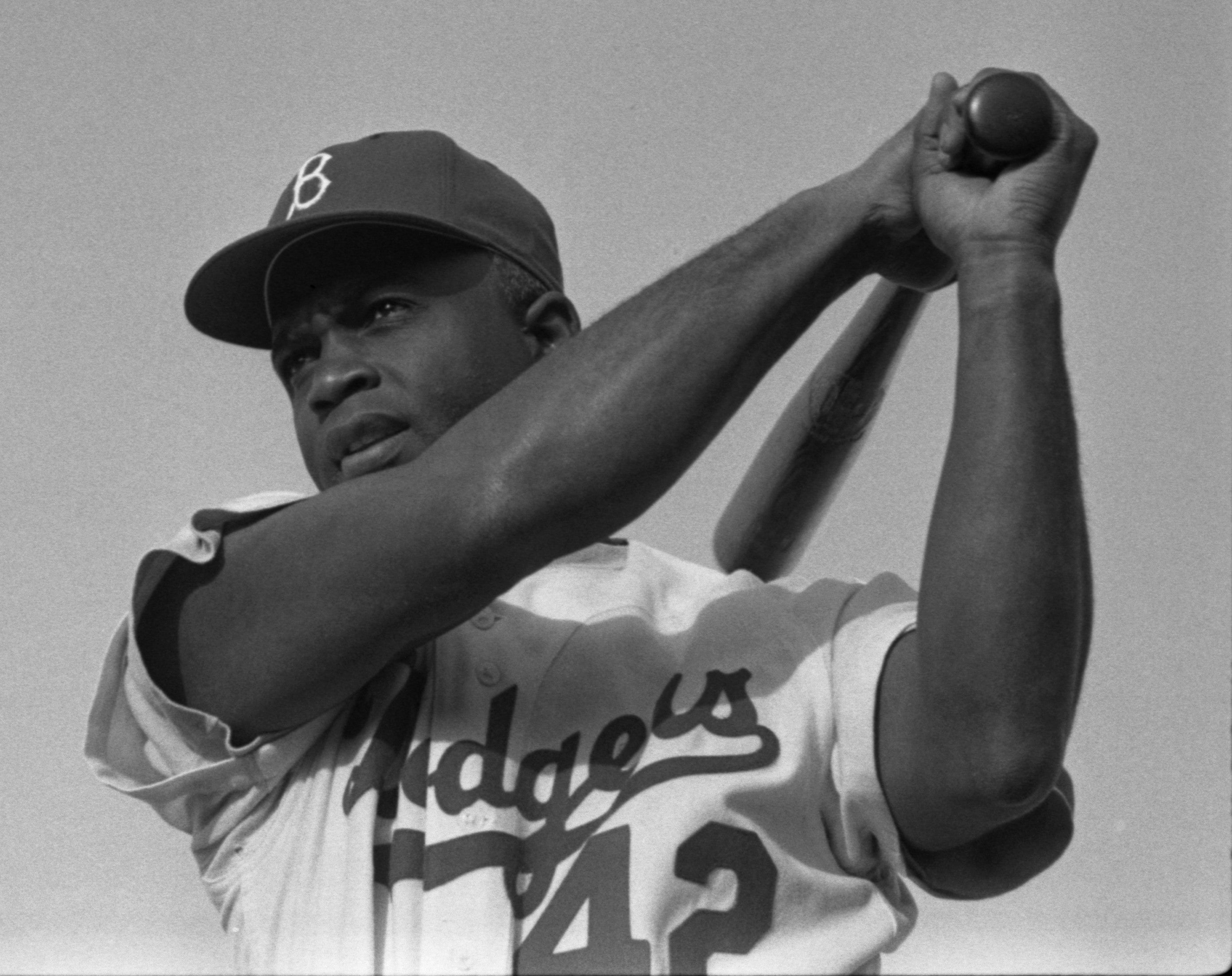 Black and white photo of Jackie Robinson playing baseball